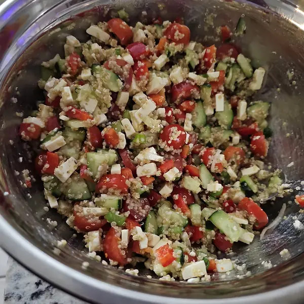 Quinoa salad with tomatoes, cucumber and cheese