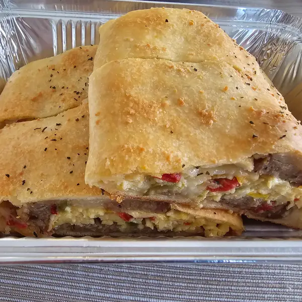 Sliced stromboli with sausage, egg and peppers